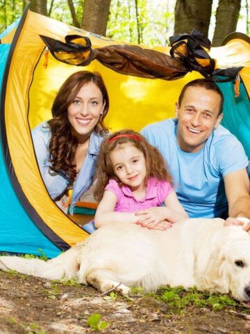 family and dog in a tent